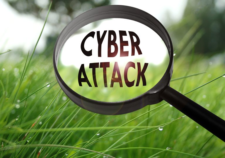 cyber attack on grass through a magnifying glass
